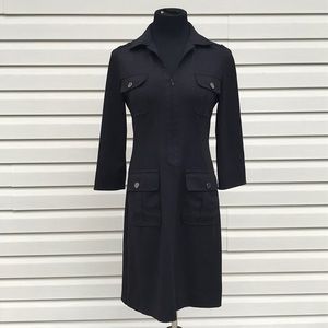 Etcetera black dress with pockets in front.